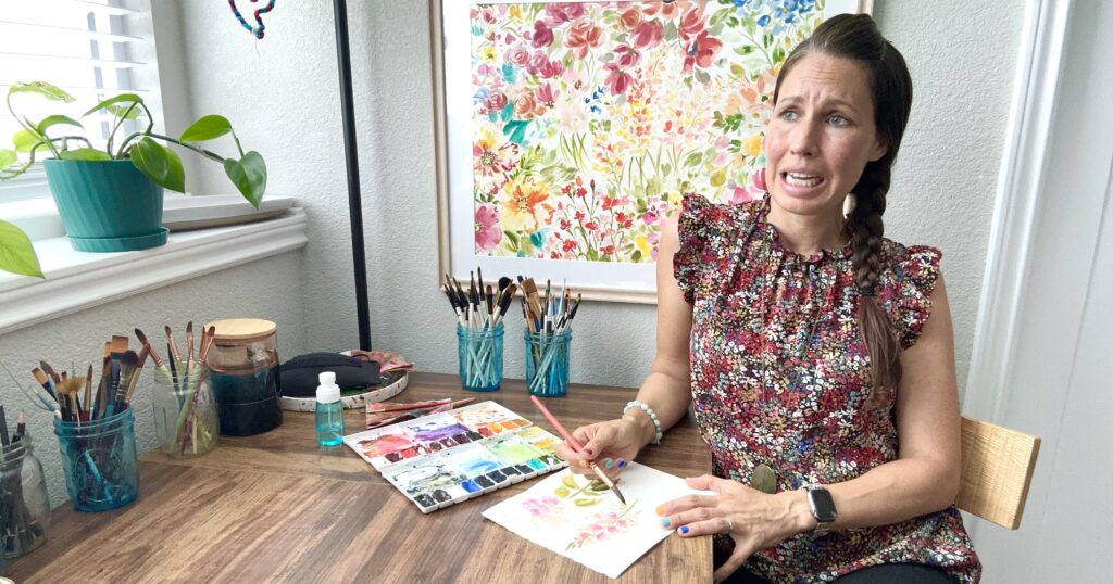 woman with scared face painting a flower